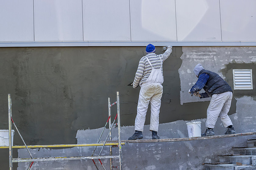 two technicians completing stucco repair in Palm Bay, FL